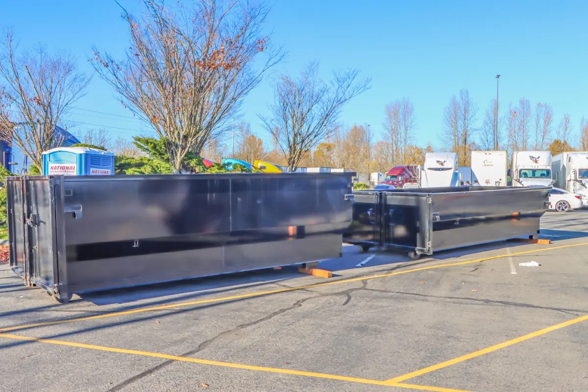 Professional dumpster rental service with roll-off container on residential driveway in Billerica